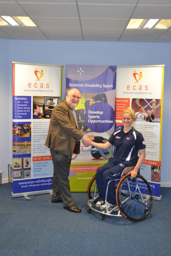 David Griffiths, chief executive of Ecas, with Robyn Love and her new basketball wheelchair