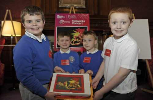  Children from the LCC class at St Cuthbert's Primary School celebrate their win with a cake decorated with their design Photo ©Neil Hanna