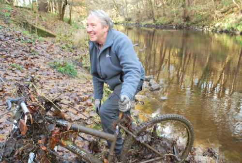 Fisherman Scot Muir pulls a bike from the River Almond during a clean up 