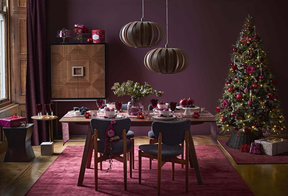 Table set for Christmas in ruby tones with matching tree